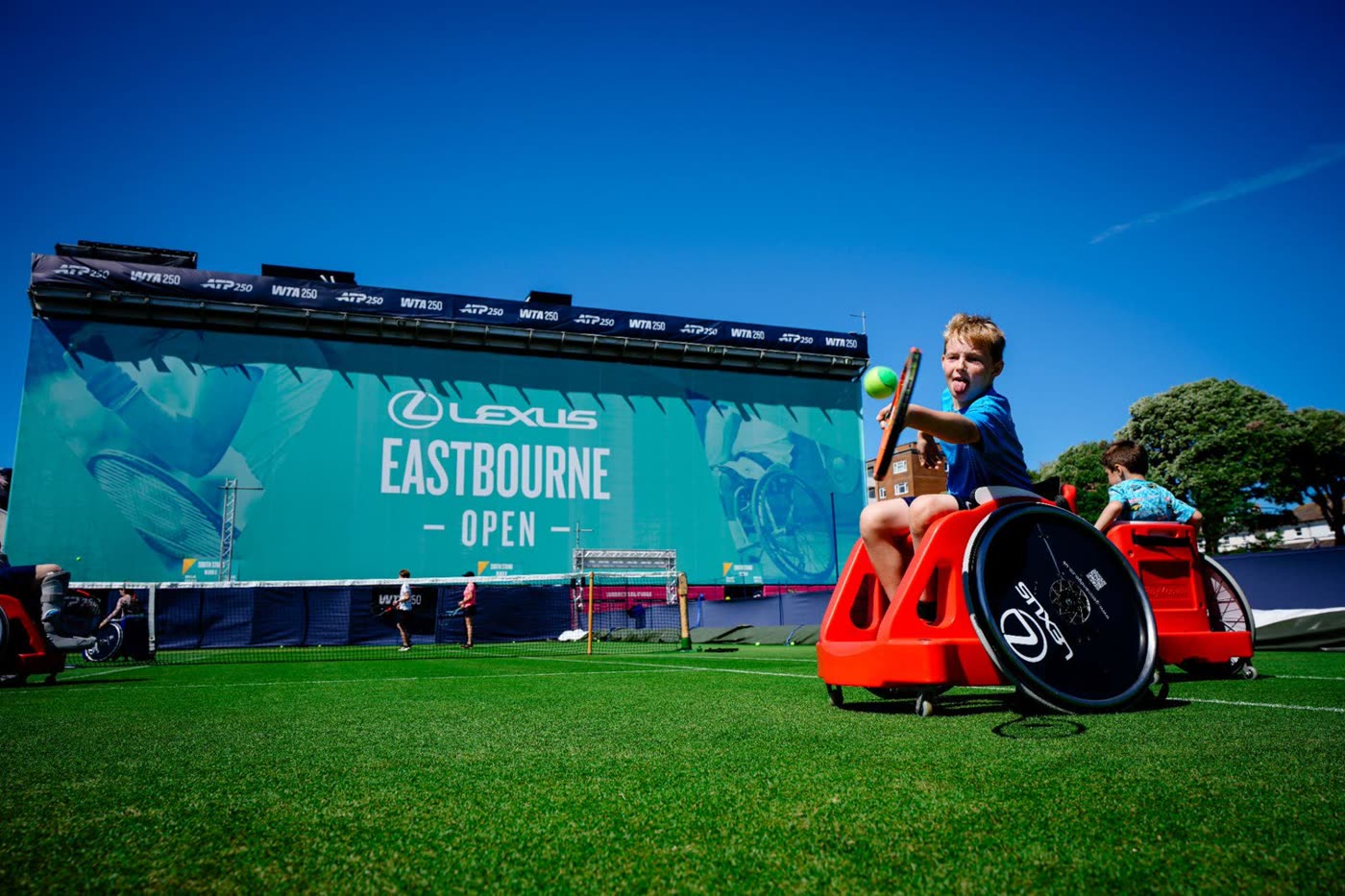 A child serving in a sport wheelchair at the Lexus Eastbourne Community Day